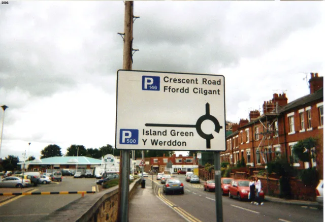 I took this picture of a Welsh language road sign near Wrexham Central railway station myself in the year 2009. I hereby release it into the public domain. Bilingual listening in Wales, handling Welsh-language posts without mistranslation