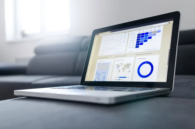Sleek laptop showcasing data analytics and graphs on the screen in a bright room. Social listening hidden costs for UK buyers: billing term, plan caps, VAT, DPIA time and exit